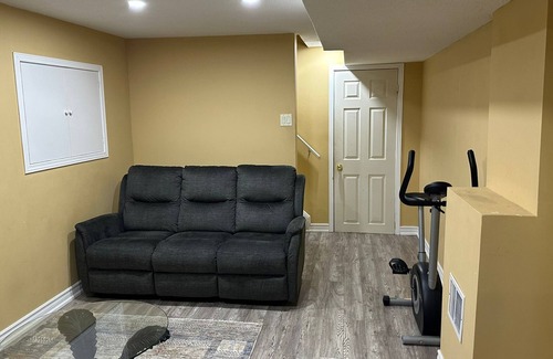 Brampton Maison | 1 bedroom basement suite with spacious living room and laundry, no kitchen.