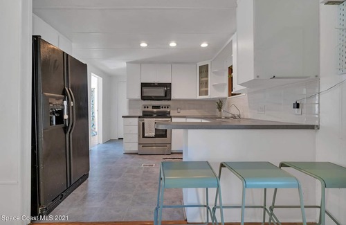 Cocoa Maison | 3 bed / 2 bath house with tropical backyard, pool, fenced yard, hammock