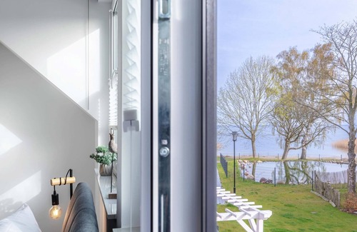 Fuhlendorf Maison | 5-star vacation home Ostseetraum on the water with fireplace, terrace and Bodden view