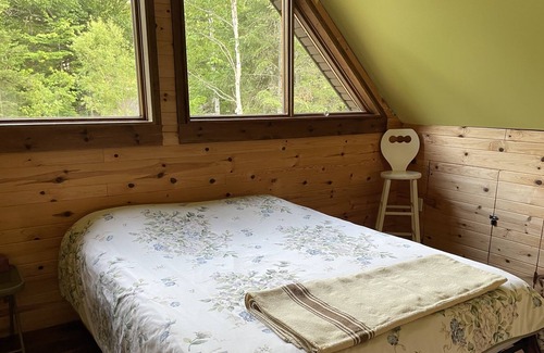 Notre-Dame-Des-Bois Cabine | A cozy rustic mountain side cabin with a small river on the property.