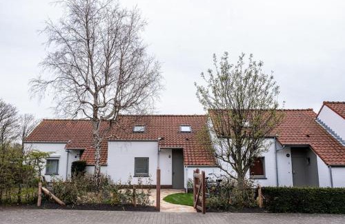 Nieuwpoort Maison | 'A little white house with a tree by the sea' with beach cabin by BLOSS
