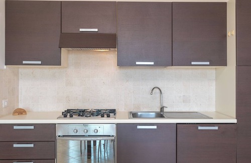 Porto Pozzo Appartement | Appartement 'Il Fiordo 16' avec vue sur la mer, piscine partagée et climatisation
