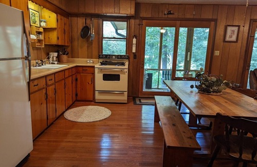 Harrisonville Cabine | Backyard creek, screened porch