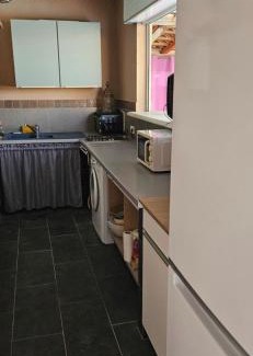 Aleria Maison | Bed and kitchen with pool