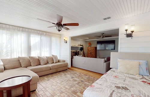 Spring Hill Maison | Bright & charming beach retreat with large lanai, firepit, & fireplace - dogs ok