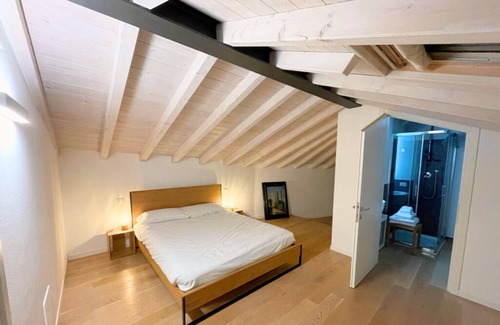 Bassano del Grappa Appartement | Casa Tonde, a modern attic with exposed beams.