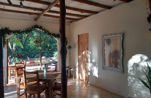 Buenos Aires Chalet De Ski | Chalet with jungle view deck on a river in lively Santa Teresa's surf town