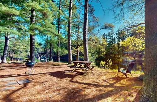Manitowish Waters Cabine | Charming waterfront cottage with shared firepit, canoe, paddlebaot & docks