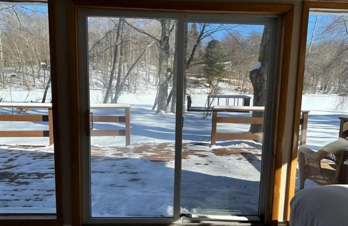 Swan Lake Cottage | Cozy lakeside cottage with modern furniture on a quiet street.