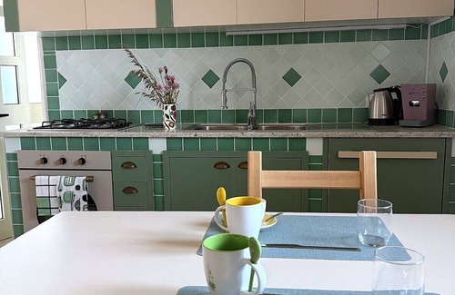 Lustra Maison | Cozy room on two floors with kitchen and bedroom upstairs.