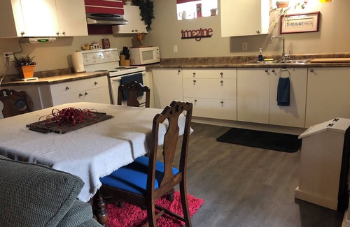 Township of Woolwich Appartement | Doggy heaven. Large fenced yard with guest deck, fire pit and beautiful gardens.