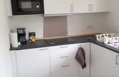 Steinhoefel Appartement | Ehemalige Bibliothek: Küche Kamin Netflix Hofladen