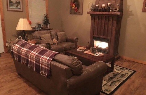 Spencer Maison | Gas fireplace, firepit, and cedar Adirondack chair