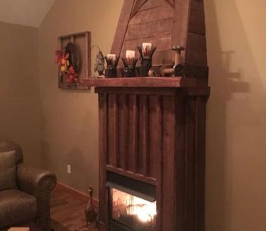 Spencer Maison | Gas fireplace, firepit, and cedar Adirondack chair