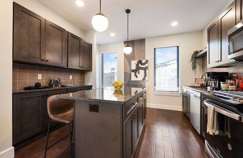 Central Northside Maison | ★ HostWise Stays ★ 3 King Beds! Garage! Theater! Great Location!