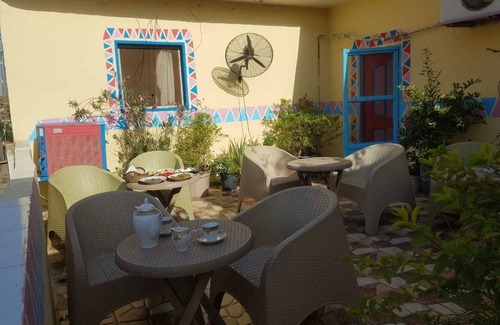 Giza Maison | It's a house .it has aquit roof with a view of pyramids