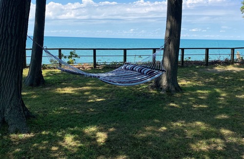 Irving Maison | Lake Front Home. Private stairs to private beach and bay. upscale 5 bedroom home