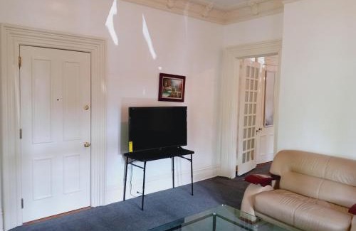 Plainfield Maison | Mini Mansion Hotel near public transportation is the yellow and green house on the corner of 8th st and Madison avenue