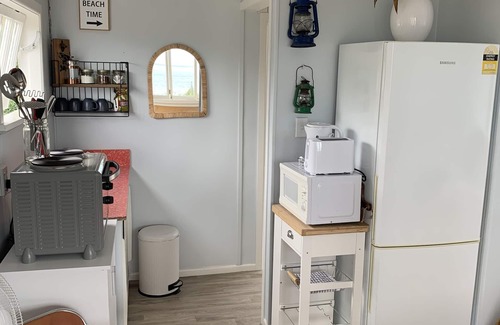 Cape Palliser Maison | Ocean views of the Kaikoura's and surf break. Private beach hut.