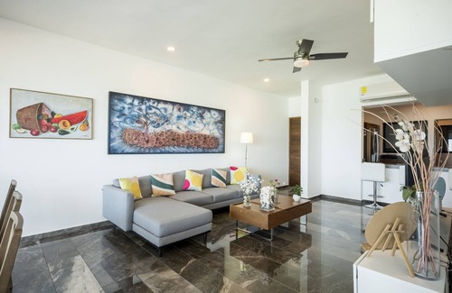 Ixil Appartement | Oceanfront retreat with private balcony, outdoor pool, and stunning views