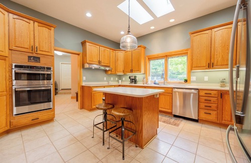 Dublin Maison | Private lakefront home with dock, forest views, balconies, game room, and cozy indoor charm