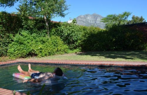 Die Boord Maison | Retro Red Stone Villa with pool & lush garden