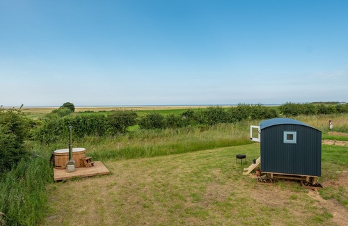 Wells-next-the-Sea Cabine | This bespoke hut is situated on the edge of the marsh with uninterrupted views out to the sea.