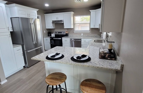 Guthrie Maison | Spacious 5-bedroom house with covered parking and private backyard in Guthrie.