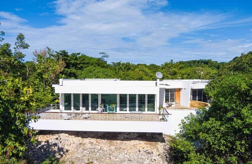 Borinquen Villa | Stunning 1950's grand house nestled in lush greenery overlooking the bay