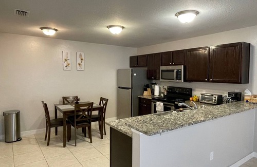 Duval Maison | Stylish Home in Duval w/Granite, Tile Floors, Glass Lanai & Gas Golf Cart!