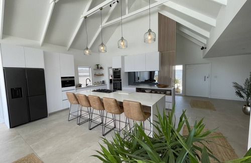 Grotto Bay Maison | Tranquil haven: home in nature's embrace, where ocean and dunes unite.
