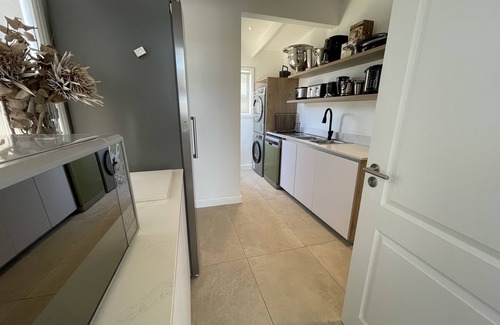 Grotto Bay Maison | Tranquil haven: home in nature's embrace, where ocean and dunes unite.