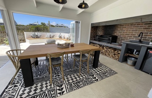 Grotto Bay Maison | Tranquil haven: home in nature's embrace, where ocean and dunes unite.