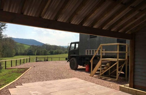 Usk Maison | Unique stay in your very own army truck. Sleeps 4. Hot tub. Tranquil setting.