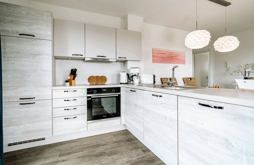 Schillig Appartement | Vacation apartment with a view of the sea and meadows, sauna & electric fireplace for relax