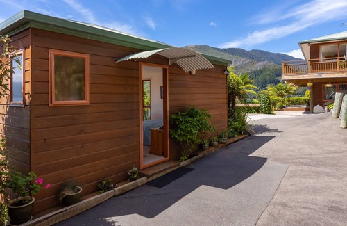 Whatamango Bay Cottage | Waterfront cottage nestled in native bush with epic views