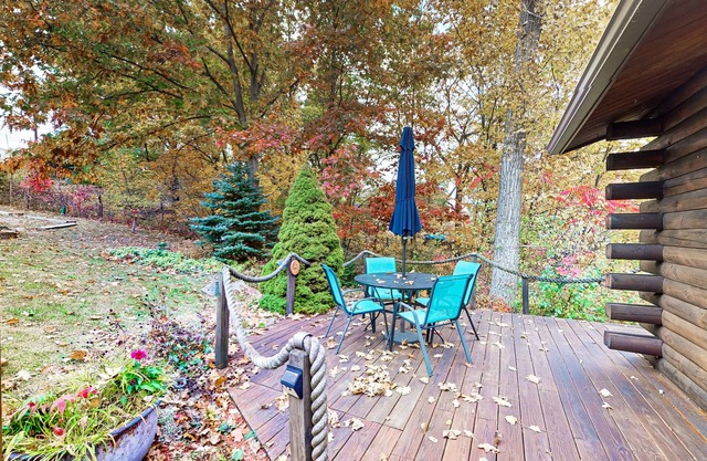 1-acre lakefront log cabin with dock, 50 ft water frontage, hot tub, & deck
