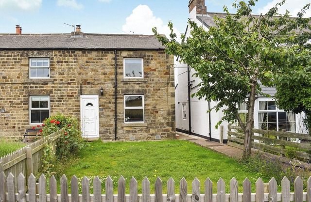 The enchanting Cozy Cow Cottage in Belford is surrounded by picturesque landscapes.