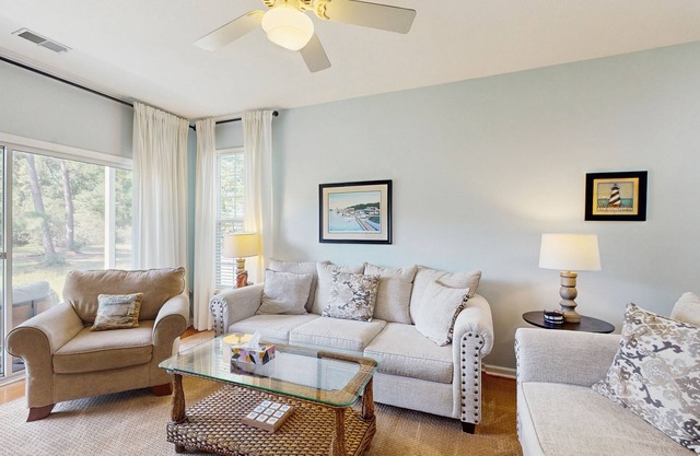 1st-floor corner condo with water view, on-site pool, & screened patio
