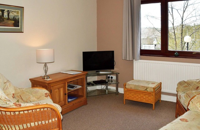 Delightful apartment with pleasant views, overlooking Bowness with private parking.