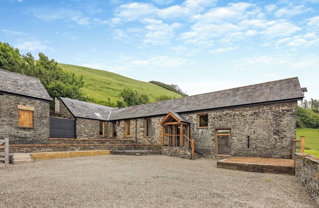Ty Carreg is a stunning barn conversion with views over the rolling hills near Aberystwyth.