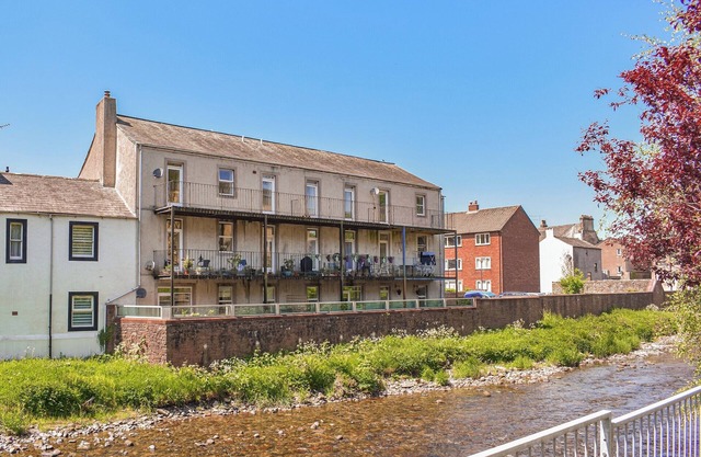 Riverside apartment with private balcony and direct views over the river.