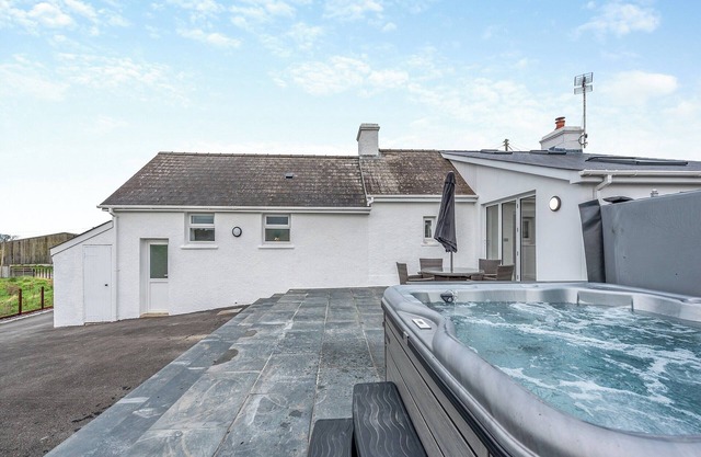 Boasting your very own hot tub, with views across the meadows, and less than 3 miles to the beach.