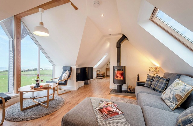 A luxury barn conversion set in an elevated position with breath-taking sea views.