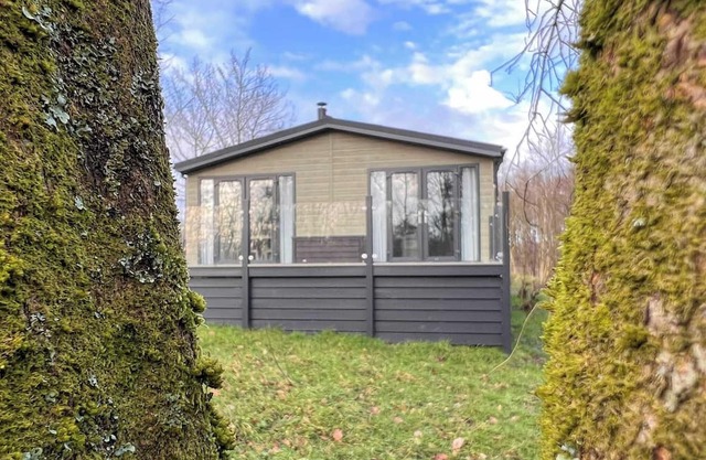 Escape to this stunning woodland lodge, where natural beauty meets modern comfort.