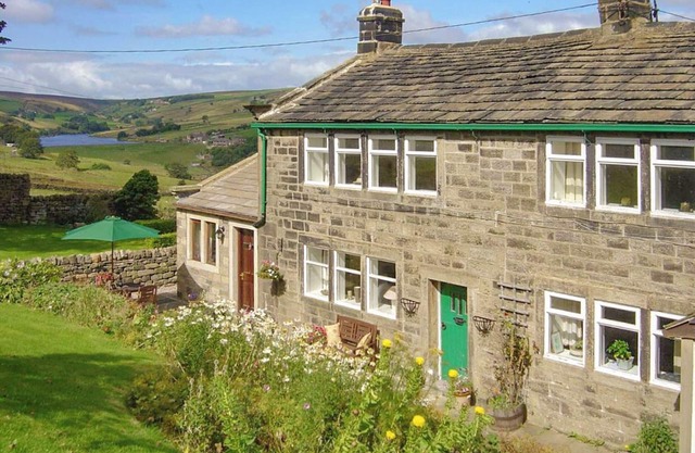 Royds Hall Cottage is a charming two-bedroom holiday home that sleeps up to four guests.