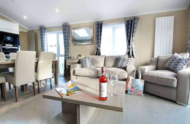 Contemporary caravan with one double with en suite shower and one twin both with flatscreen TV.
