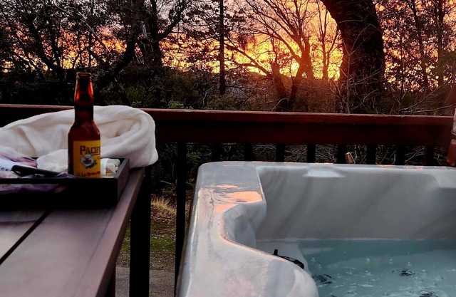 2 Br 2 Ba upstairs in cabin w/hot tub on 5.6 acre. Next to a Creek/near a lake