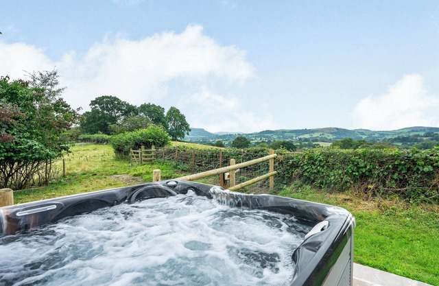 Lovely detached bungalow with views of the Mid Wales countryside with private hot tub.