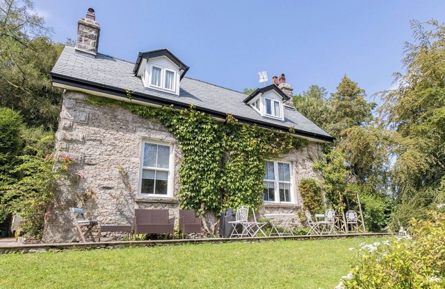 A detached property with amazing views to the coast, a private hot tub and beautiful gardens.